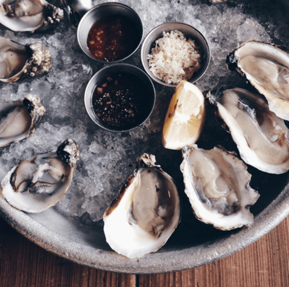 fresh oysters and sauce on a bed of ice