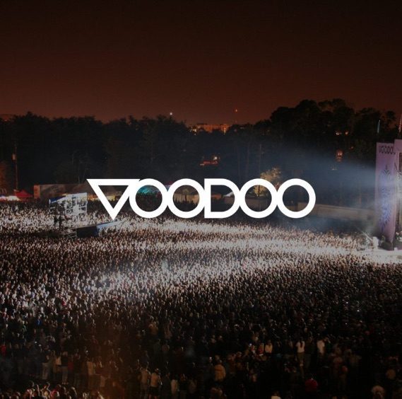 crowd at music festival in front of stage at night time